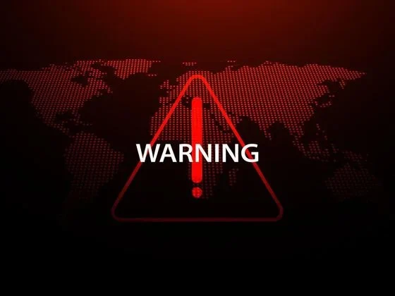 Red warning sign over a dotted world map