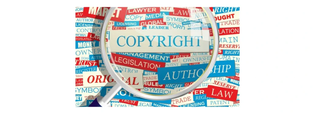 Magnifying glass over a collage of copyright and law related words